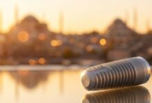 A photorealistic image of a sterile, high-quality dental implant resting on a clean surface. In the background, a beautiful and softly blurred panoramic view of the Istanbul, Turkey skyline is visible at sunrise, symbolizing dental tourism.