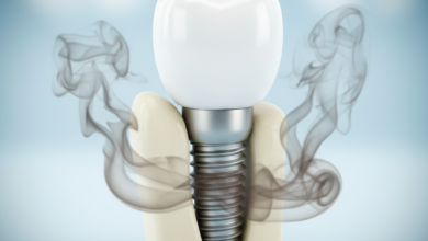 Photorealistic image of a perfectly set, healthy dental implant with a white crown, surrounded by a subtle, ominous cloud of dark grey and brownish smoke, symbolizing the risks of smoking to implant success. The background is blurred and neutral.