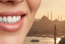 A close-up, photorealistic image of a subtle, confident smile with bright, perfectly aligned teeth and healthy lips, set against a beautifully blurred, warm-toned backdrop of a Turkish cityscape at sunset or sunrise.