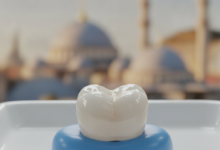 A close-up, high-definition image of a perfectly sculpted, white dental crown, gleaming under bright, professional lighting. The background is a soft blur of a modern dental clinic, with distant, indistinct architectural shapes suggesting a city like Istanbul.