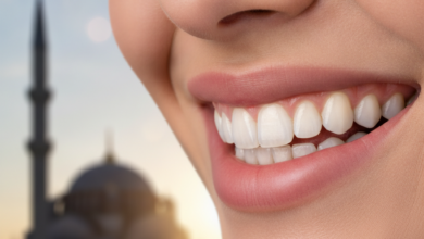 Close-up of a flawless, bright white human smile, subtly featuring a dental crown that blends seamlessly with natural teeth. The background is a beautifully blurred, warm-toned hint of traditional Turkish architecture, like a mosque dome, under cinematic lighting with shallow depth of field.