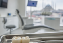 A close-up, highly detailed image of a flawless ceramic dental crown on a sterile dental tray or model. The background is a softly blurred, modern dental clinic with an out-of-focus view of a Turkish city skyline, symbolizing dental tourism in Turkey.