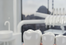 A close-up, photorealistic image of a perfectly fitted and gleaming dental crown on a tooth, set in a modern, brightly lit dental clinic. The background is softly blurred, showing abstract clinic equipment and a faint, indistinct silhouette of a Turkish cityscape through a window.