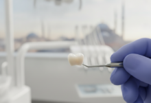 Close-up of a radiant, perfectly formed dental crown held by gloved hands against a blurred backdrop of a modern dental clinic and a soft-focus Turkish cityscape, symbolizing high-quality dental tourism.
