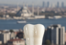 A close-up, photorealistic image of a perfectly shaped, brilliant white dental crown, with a modern, blurred cityscape of Istanbul, Turkey in the background. The image has soft, professional lighting and a shallow depth of field, focusing on the crown.