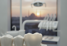 Close-up of a perfectly crafted, highly aesthetic dental crown showcasing natural translucency and strength, with a blurred background of a modern dental clinic and a distant, out-of-focus Turkish city skyline.